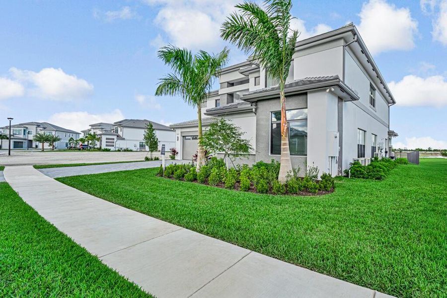 Front exterior of a new home in Apex at Avenir, Palm Beach Gardens, FL, highlighting curb appeal (Image 1). Front exterior of a new home in Apex at Avenir, Palm Beach Gardens, FL, highlighting curb appeal (Image 1).
