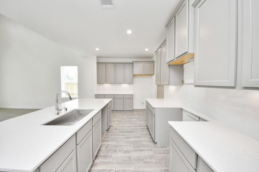 The kitchen is a culinary haven, featuring granite countertops, a tile backsplash, stainless steel appliances, 42” upper cabinets, and undercabinet lighting. The kitchen is a culinary haven, featuring granite countertops, a tile backsplash, stainless steel appliances, 42” upper cabinets, and undercabinet lighting.