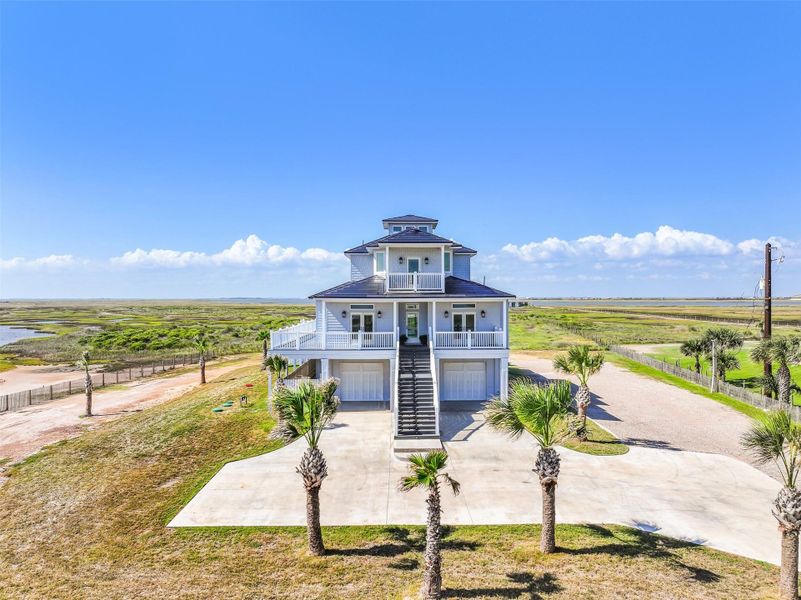 Step back and take it all in: lush greens, sparkling pool, covered porch, and Gulf beyond. The home radiates serenity, inviting you to linger, entertain, and relax in a setting that feels like a permanent retreat.