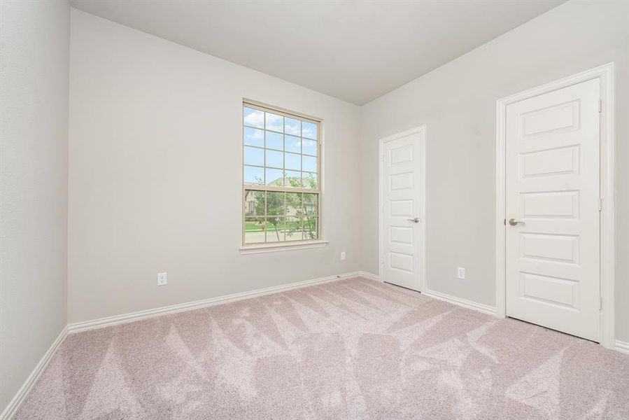 Unfurnished bedroom with light carpet