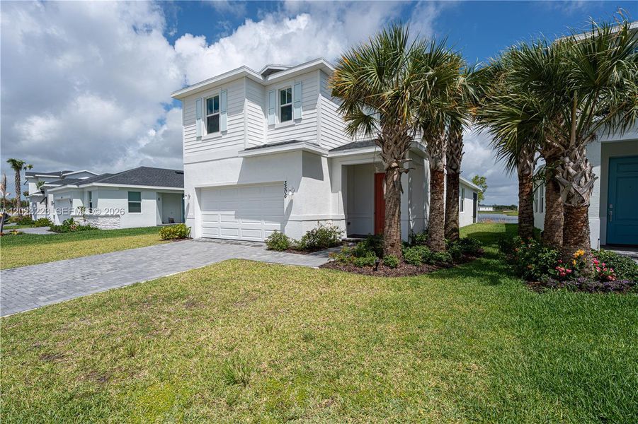 Front exterior of a new home in Seagrove, Fort Pierce, FL, highlighting curb appeal (Image 24). Front exterior of a new home in Seagrove, Fort Pierce, FL, highlighting curb appeal (Image 24).