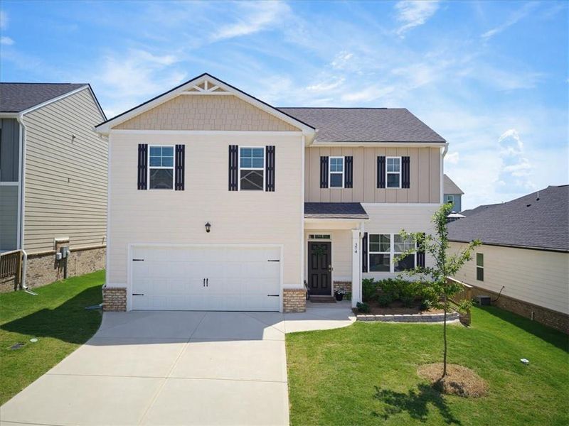 Front exterior of a new home in Twin Lakes, Hoschton, GA, highlighting curb appeal (Image 27). Front exterior of a new home in Twin Lakes, Hoschton, GA, highlighting curb appeal (Image 27).