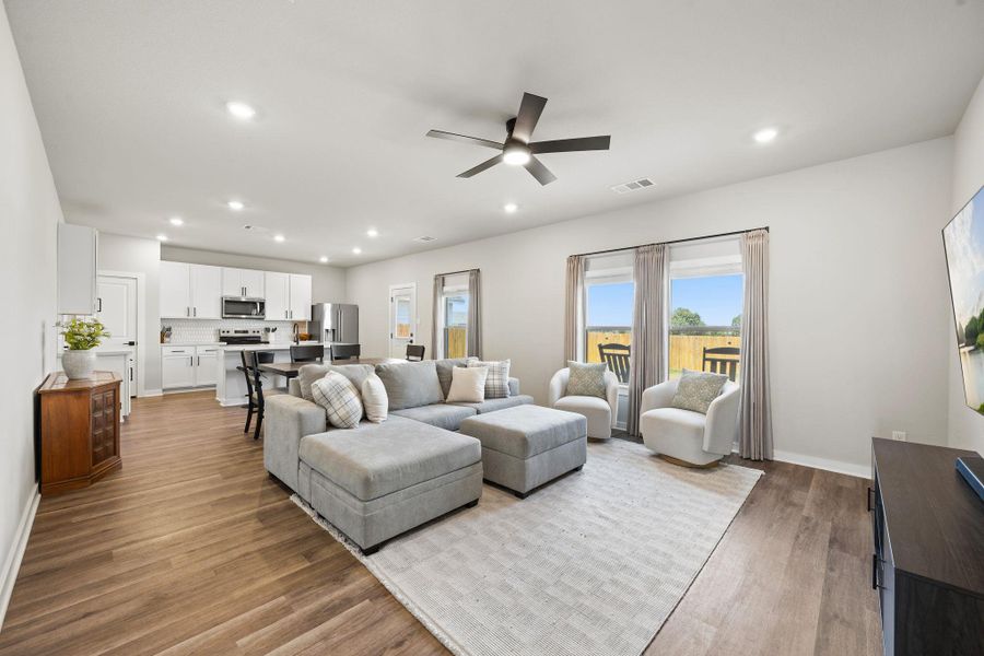 Warm wood flooring grounds this airy, open-concept living area with abundant natural light. Warm wood flooring grounds this airy, open-concept living area with abundant natural light.