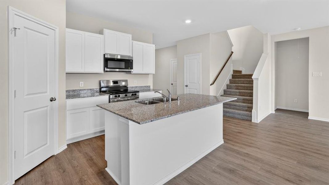 Modern kitchen with white cabinetry and stainless steel appliances