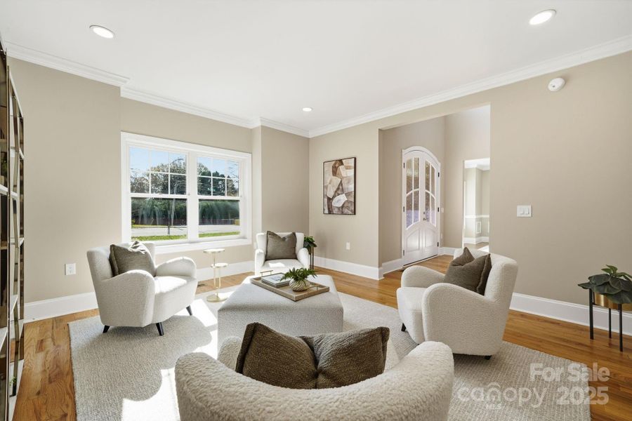 Stylish front living room with designer seating and abundant natural light. Stylish front living room with designer seating and abundant natural light.