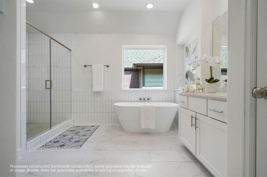 Ensuite Elegance: Step into the primary suite's ensuite bathroom, boasting abundant space and luxurious finishes, including a spa-like shower adjacent to the elegant freestanding tub.