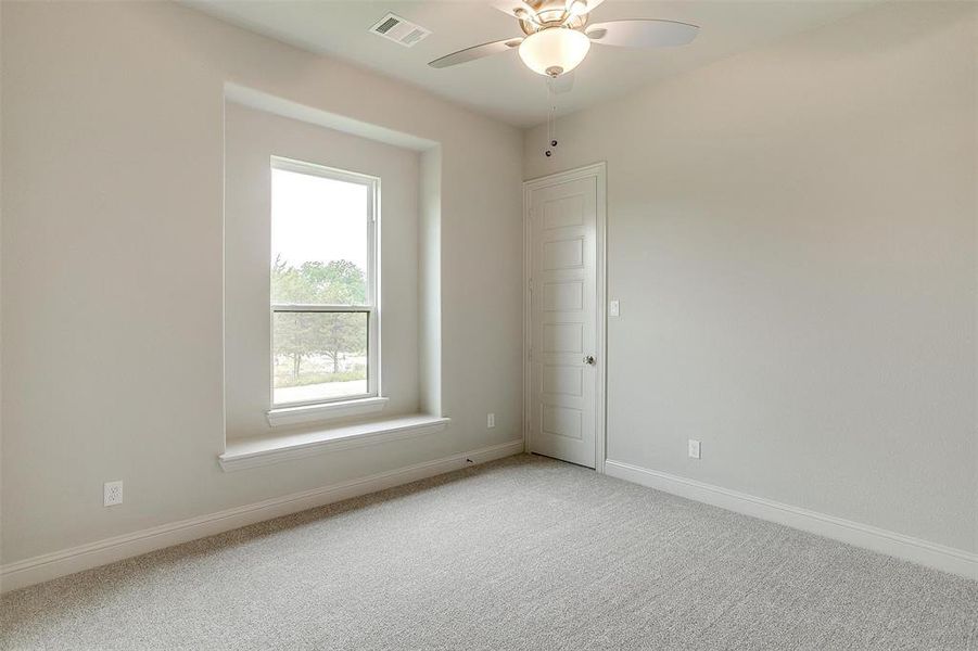 Spare room with light colored carpet and ceiling fan