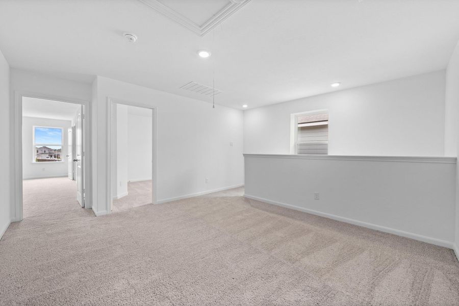 Spare room featuring light colored carpet, attic access, plenty of natural light, and recessed lighting Spare room featuring light colored carpet, attic access, plenty of natural light, and recessed lighting