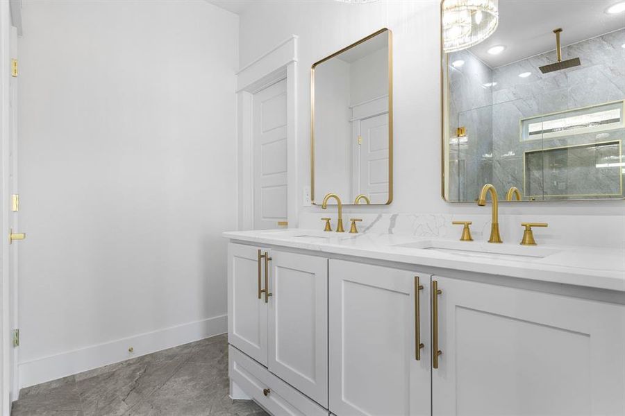 Bathroom featuring tile patterned floors, vanity, and tiled shower