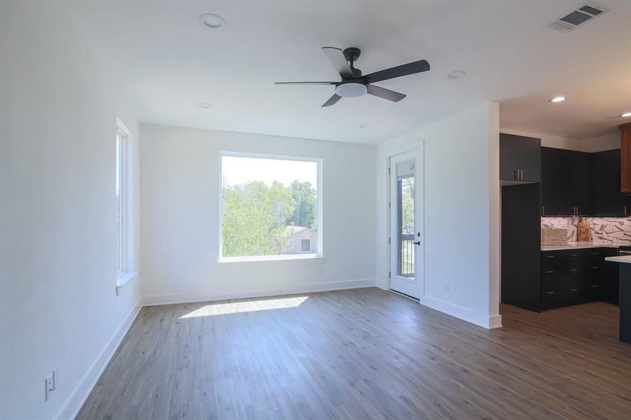 Spare room with wood-type flooring and ceiling fan