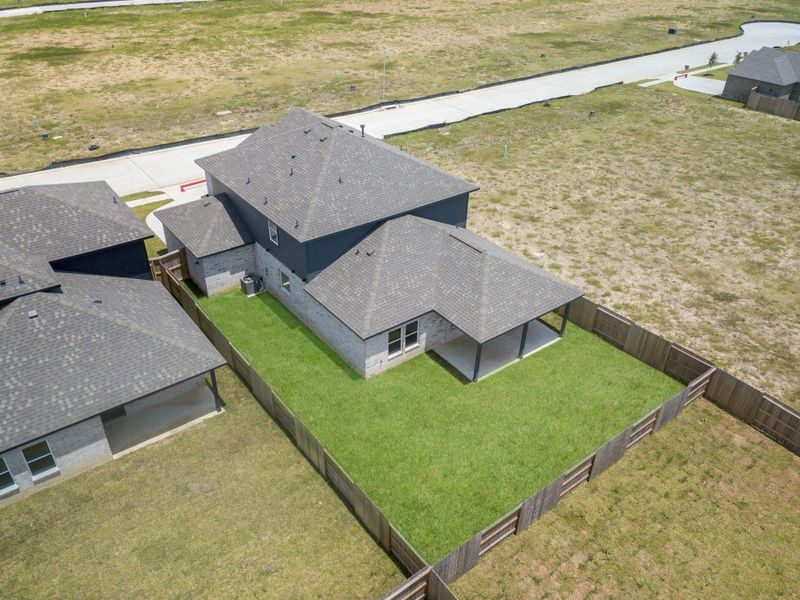 Aerial view of the backyard and surrounding lots, showing the generous outdoor space. Aerial view of the backyard and surrounding lots, showing the generous outdoor space.