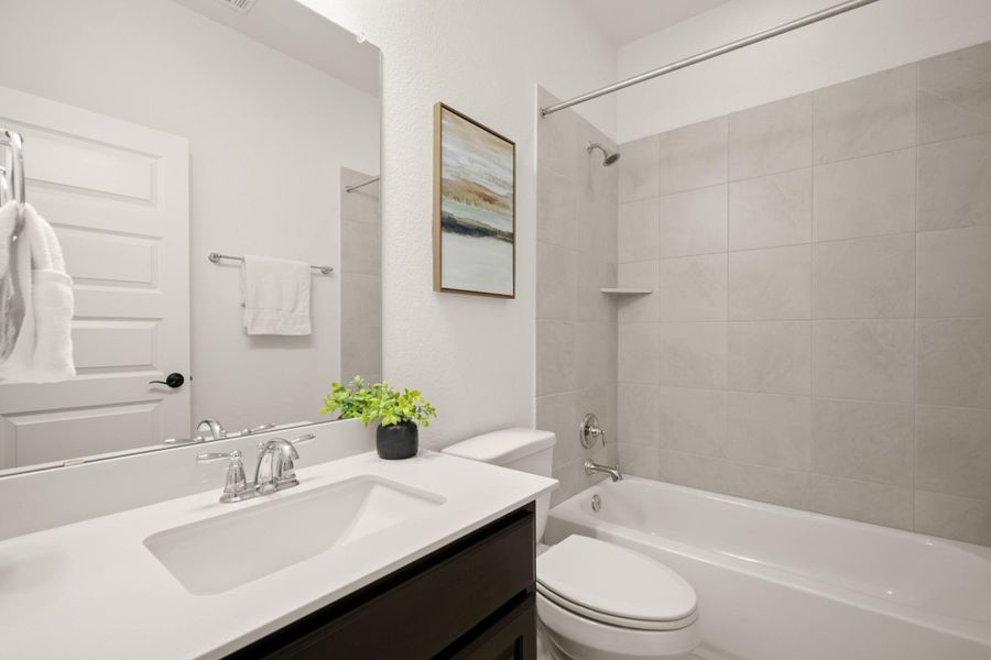 This full guest bath is located in between one of the secondary bedrooms and the game room. This full guest bath is located in between one of the secondary bedrooms and the game room.