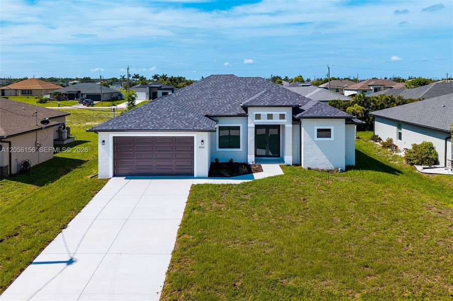 Front exterior of a new home in , Cape Coral, FL, highlighting curb appeal (Image 20). Front exterior of a new home in , Cape Coral, FL, highlighting curb appeal (Image 20).