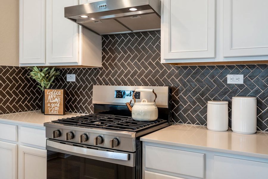 Glossy tile backsplash in herringbone pattern Glossy tile backsplash in herringbone pattern