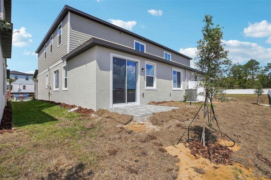 Front exterior of a new home in Cyrene at Minneola - Villas, Montverde, FL, highlighting curb appeal (Image 20). Front exterior of a new home in Cyrene at Minneola - Villas, Montverde, FL, highlighting curb appeal (Image 20).
