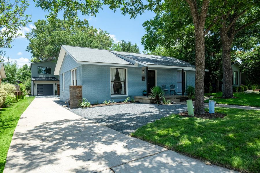 A welcoming front exterior showcasing a blend of brick and siding, framed by mature shade trees. A welcoming front exterior showcasing a blend of brick and siding, framed by mature shade trees.