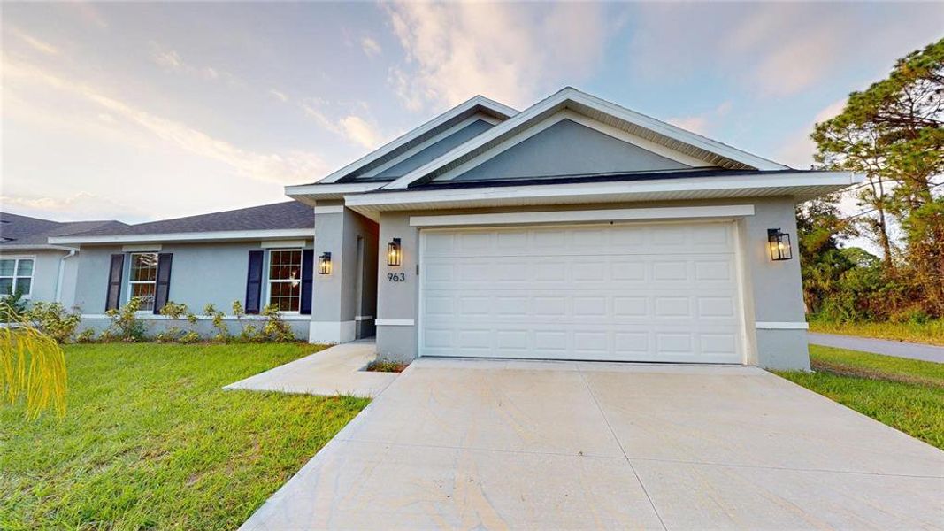 Front exterior of a new home in , Palm Bay, FL, highlighting curb appeal (Image 1).