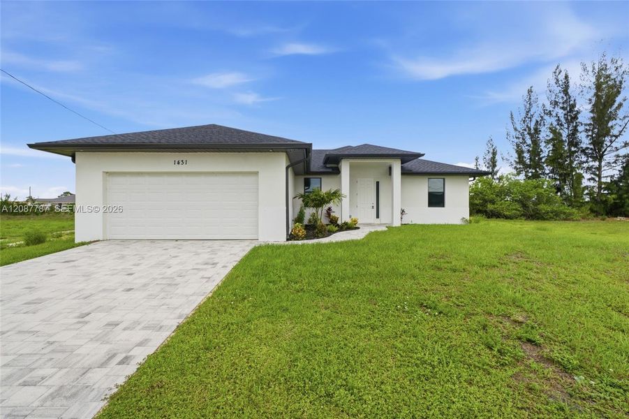 Front exterior of a new home in , Cape Coral, FL, highlighting curb appeal (Image 19). Front exterior of a new home in , Cape Coral, FL, highlighting curb appeal (Image 19).