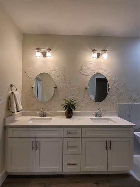 Master bathroom with double sink, custom mirrors, designer mirrors, and textured wall paint design.