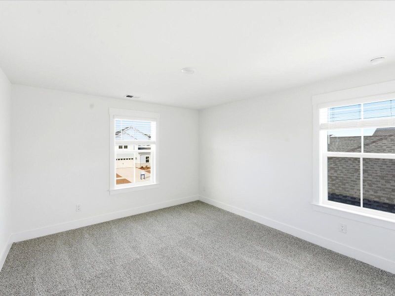 Spacious, unfurnished interior of a new home in The Coves at Lakes of Cane Bay II, Summerville (Image 21).