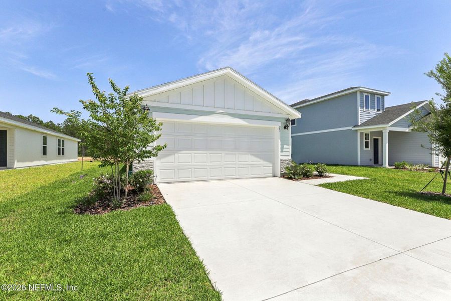 Front exterior of a new home in Flagler Village - Classic Series, Palm Coast, FL, highlighting curb appeal (Image 20).