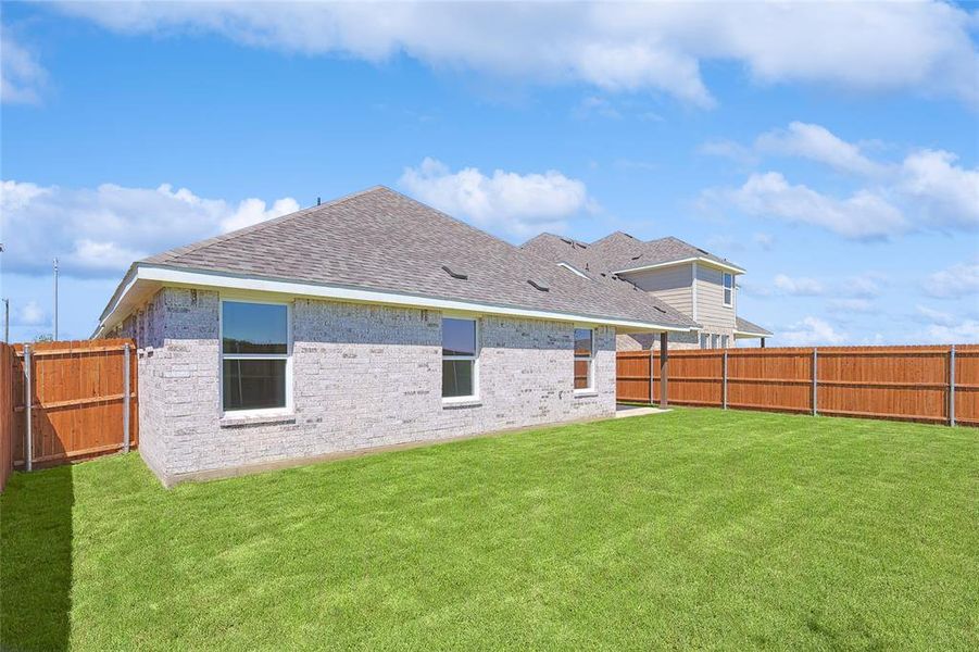 Rear view of house featuring a lawn