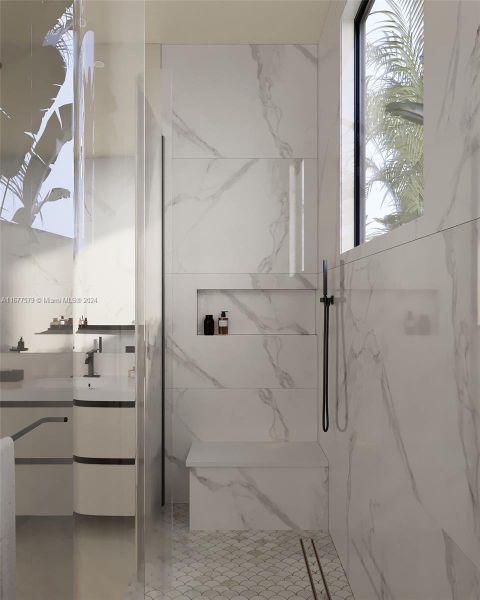 Spacious shower with a niche, bench, and frameless glass door complete this glamorous retreat.