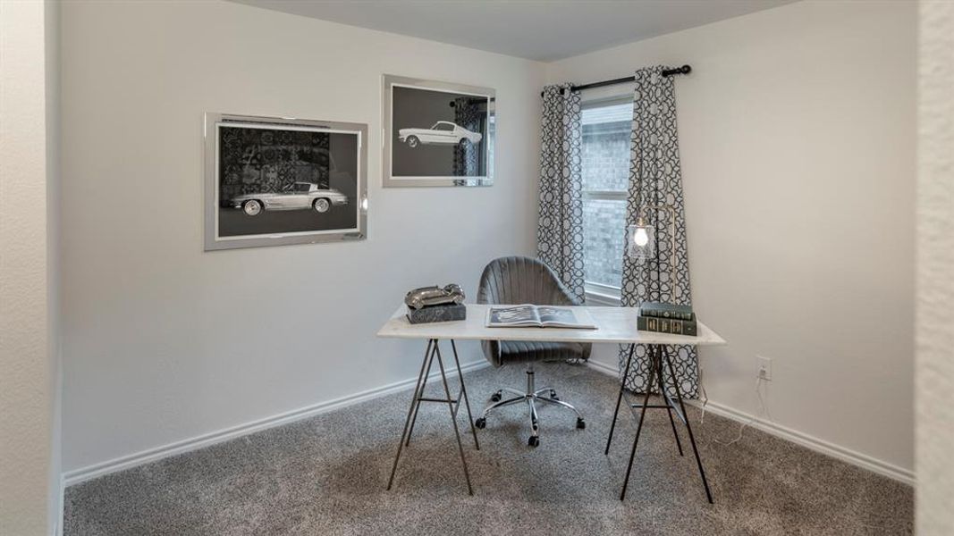 Carpeted office with baseboards