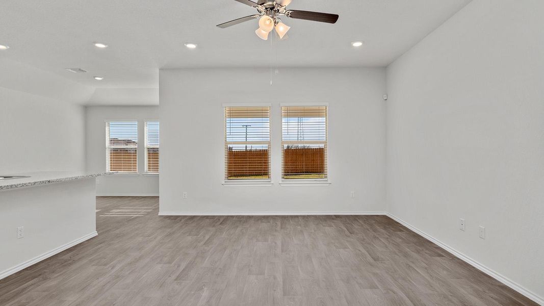 Unfurnished room featuring light wood finished floors, a ceiling fan, and recessed lighting