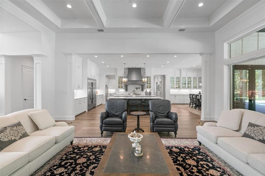 Looking towards the large kitchen from the Family room. This family room is generously proportioned and is located just off the kitchen. Notice the Architectural & decorative wood columns at the doorways.