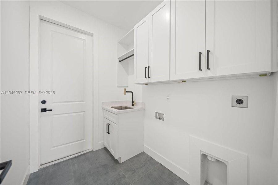 aundry room featuring custom upper cabinetry for added storage aundry room featuring custom upper cabinetry for added storage