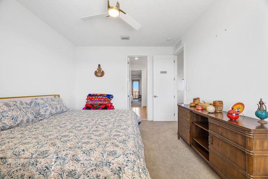 Bedroom with light carpet and ceiling fan