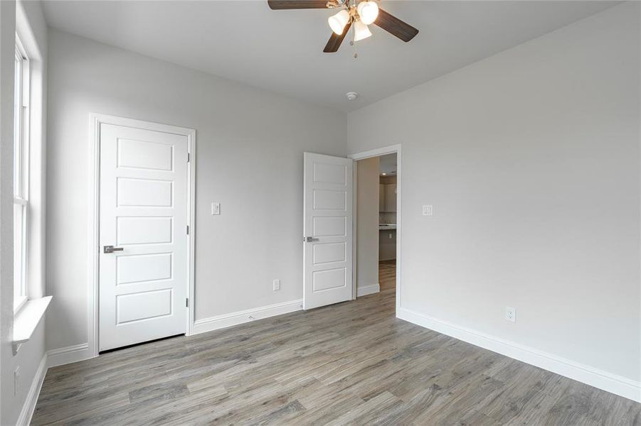 Unfurnished bedroom featuring light hardwood / wood-style flooring and ceiling fan