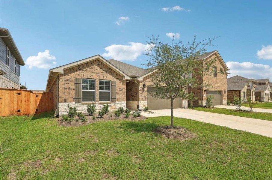 Front exterior of a new home in Wall Street Village, Richmond, TX, highlighting curb appeal (Image 1).