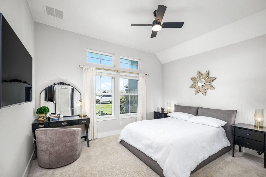 Bedroom 2 - A restful bedroom offers ample natural light and a practical ceiling fan.