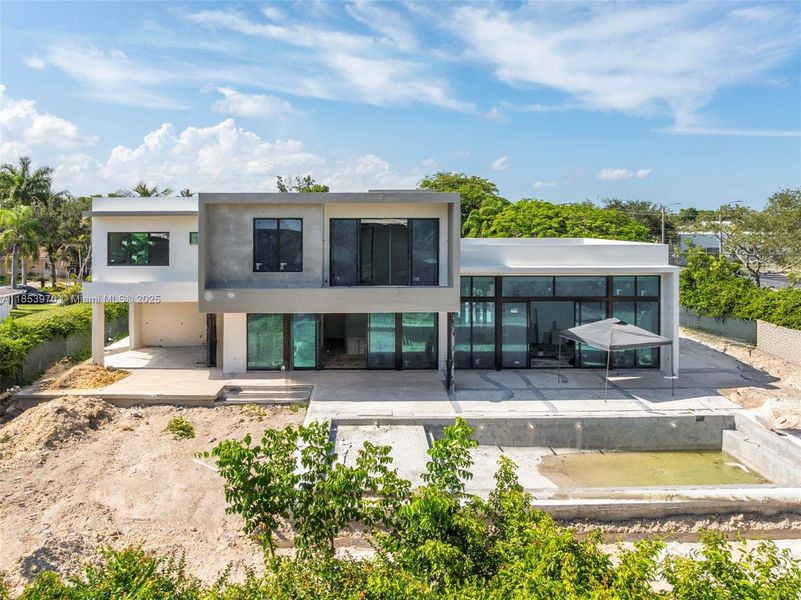 Front exterior of a new home in , Pinecrest, FL, highlighting curb appeal (Image 22). Front exterior of a new home in , Pinecrest, FL, highlighting curb appeal (Image 22).