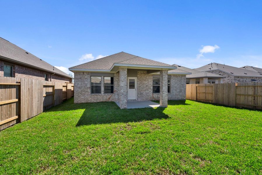 Exterior details and patio area of a home in Windrose Green, Angleton (Image 4).