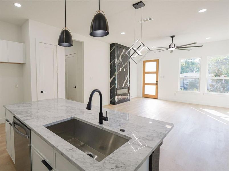 Kitchen featuring white cabinets, light stone counters, decorative light fixtures, recessed lighting, and ceiling fan Kitchen featuring white cabinets, light stone counters, decorative light fixtures, recessed lighting, and ceiling fan