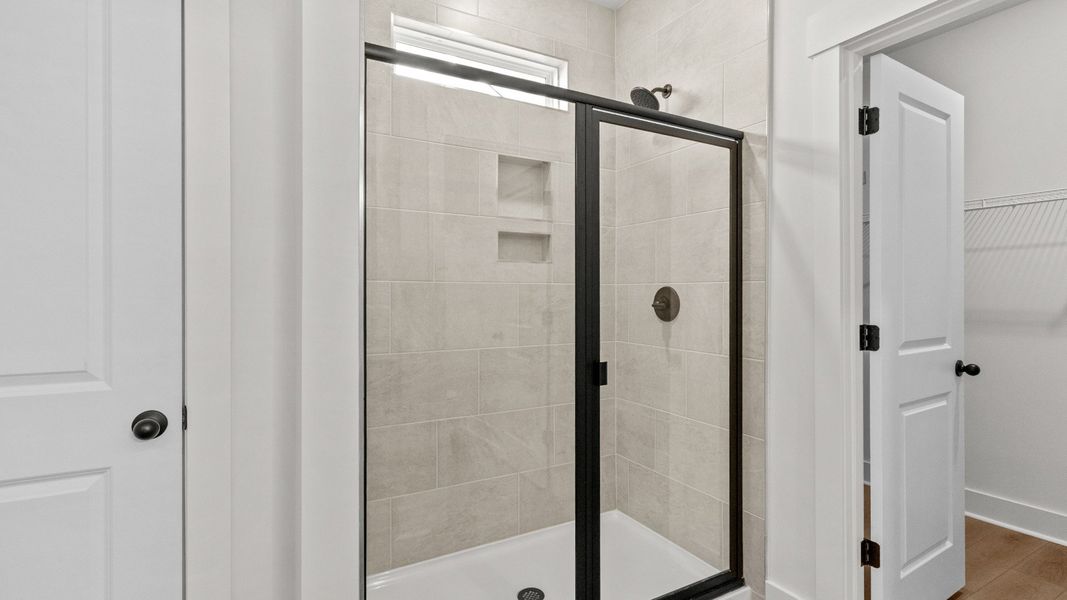 Beautiful tiled walk-in shower brings spa-like comfort to the primary suite.