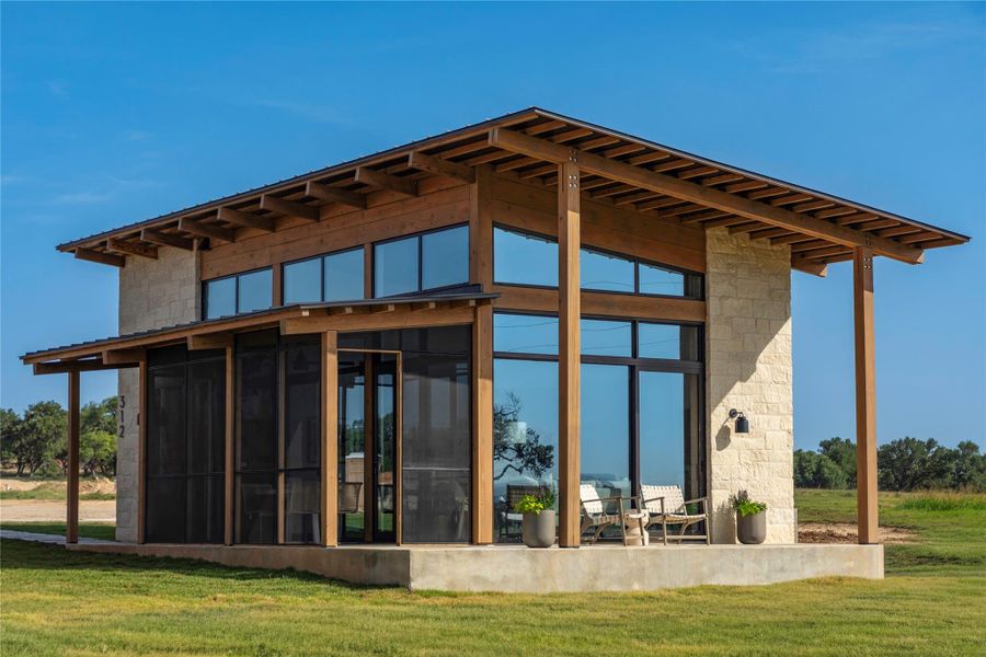 Crafted with wood and stone, this contemporary home boasts walls of windows and a screened porch. Crafted with wood and stone, this contemporary home boasts walls of windows and a screened porch.
