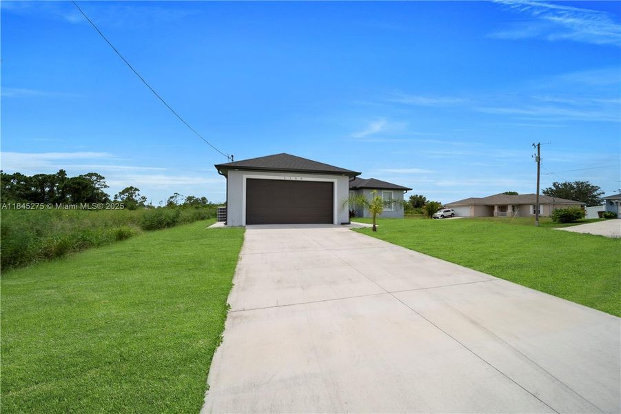 Front exterior of a new home in , Lehigh Acres, FL, highlighting curb appeal (Image 16).