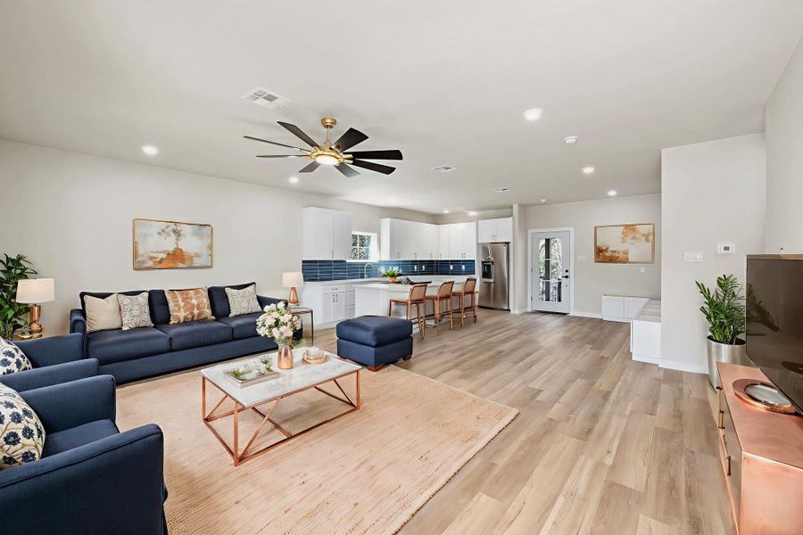 Virtually staged. Living room with recessed lighting, light wood finished floors, and ceiling fan Virtually staged. Living room with recessed lighting, light wood finished floors, and ceiling fan