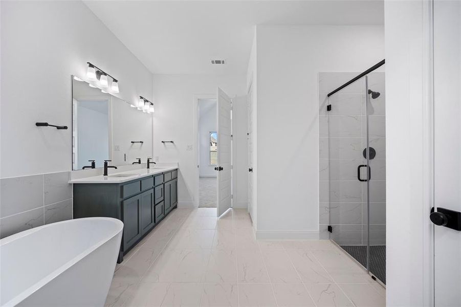 Bathroom with tile patterned flooring, plus walk in shower, and vanity