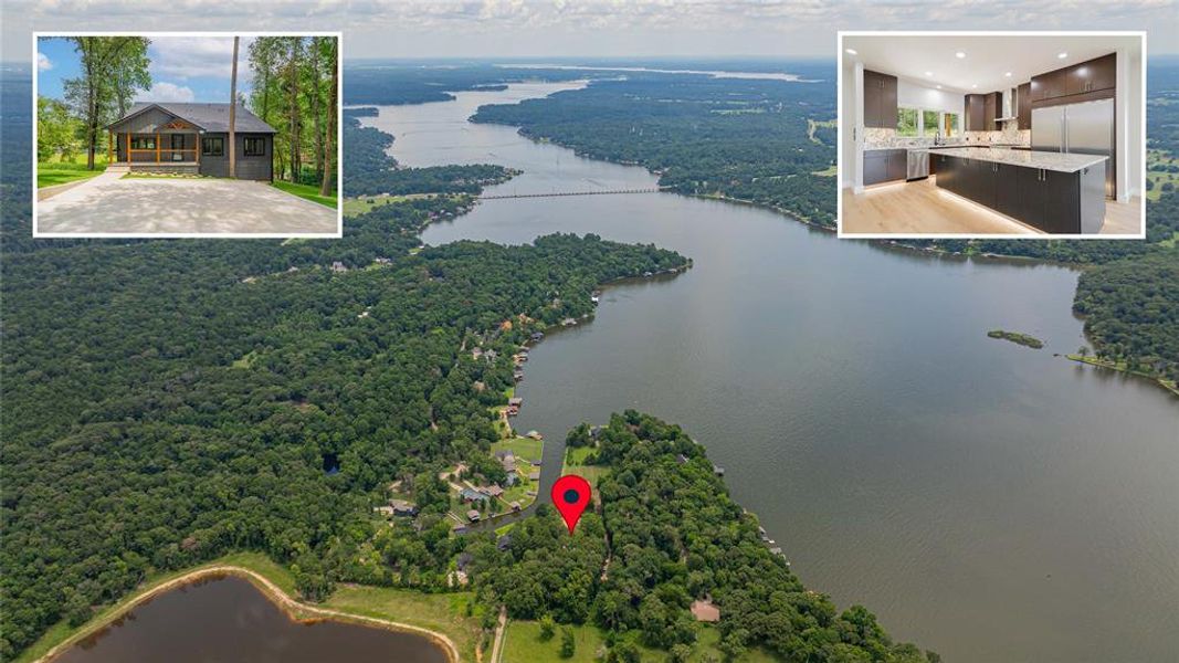 Waterfront canal featuring a dock with covered boat slips, expansive green spaces, and mature landscaping
