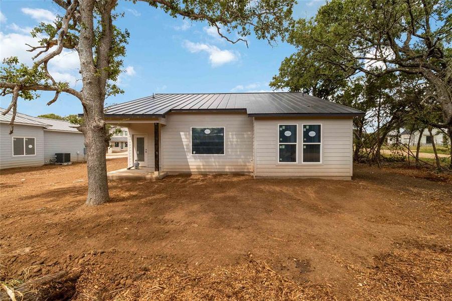 Back of home with covered patio