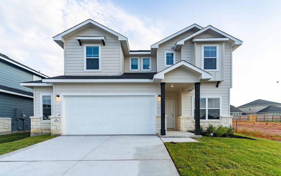 Front exterior of a new home in Swenson Heights, Seguin, TX, highlighting curb appeal (Image 1).