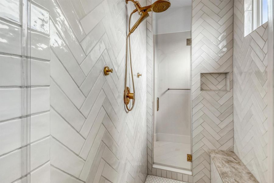 Large tile shower with window and bench seat.