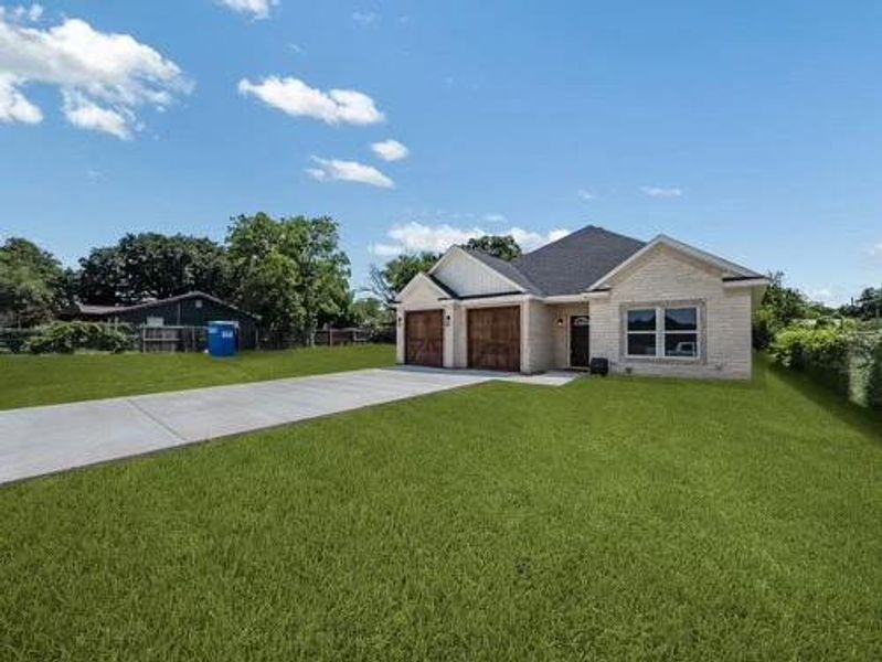 View of front of property featuring a front lawn, driveway, an attached garage, and brick siding View of front of property featuring a front lawn, driveway, an attached garage, and brick siding
