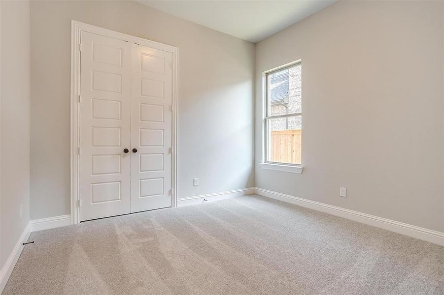 Unfurnished bedroom featuring carpet floors and a closet