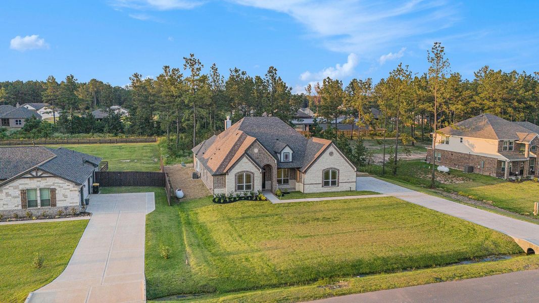 Front exterior of a new home in Deer Pines, Conroe, TX, highlighting curb appeal (Image 18). Front exterior of a new home in Deer Pines, Conroe, TX, highlighting curb appeal (Image 18).